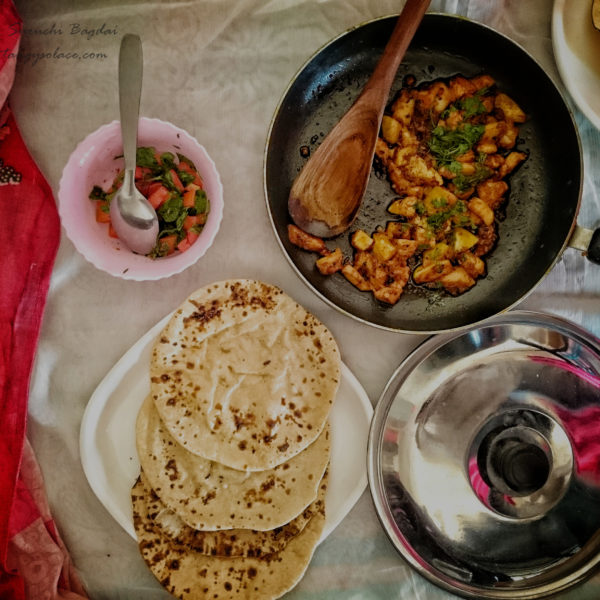 Jaam nu shaak along with phulka and kachumber over white background