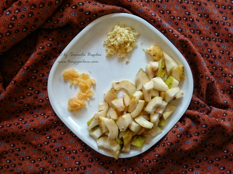 Chopped guava garlic and jaggery on white plate over brown background