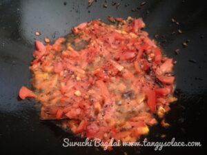 tomatoes being cooked in mustard cinnamon tempering