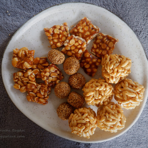 Assortment of different chikkis and laddoos on a white platter