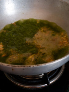 Khatti paalak paste added to oil