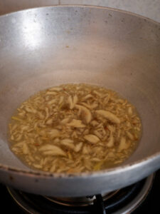 Crushed garlic being golden fried in oil