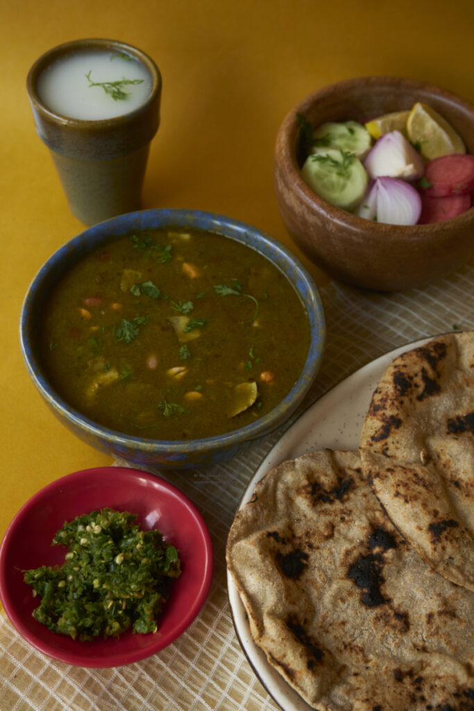mirchiya dal, cut salad, chaas, thecha and bhakri