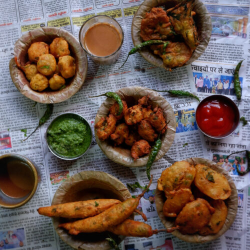 Assortment of bhajiyas served with tea, chutneys and fried chillies