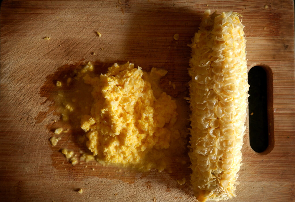 grated corn cob on chopping board