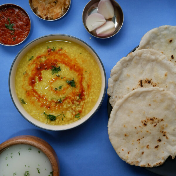 urad dal rotlo chaas lehsun chutney on blue background