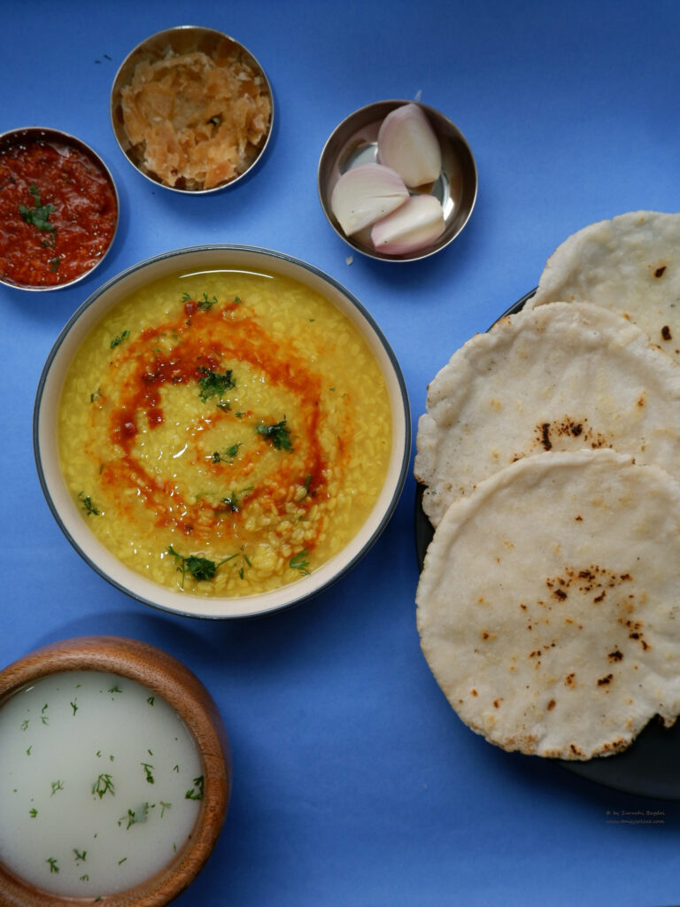 urad dal rotlo chaas lehsun chutney on blue background