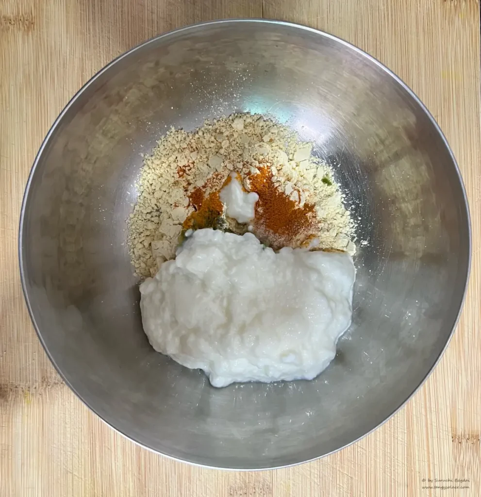 steel bowl top view with all khandvi ingredients placed except water